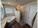 Bright main bathroom with a soaking tub and walk-in shower featuring decorative tile accents at 574 Desert Tortoise Way, Mesquite, NV 89027