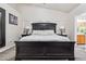 Elegant primary bedroom with a dark wood bed frame, plush carpeting, and natural light at 574 Desert Tortoise Way, Mesquite, NV 89027