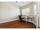 Office room features hardwood floors, bright windows, and a modern desk at 574 Desert Tortoise Way, Mesquite, NV 89027