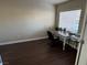 This home office features wood floors, a cream-colored desk, and ample natural light from the window at 574 Desert Tortoise Way, Mesquite, NV 89027
