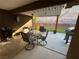 Covered patio features an outdoor dining area with seating and a grill at 574 Desert Tortoise Way, Mesquite, NV 89027