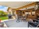 Covered patio with an outdoor dining set and bbq at 574 Desert Tortoise Way, Mesquite, NV 89027