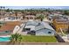 This aerial shows a fenced in backyard, manicured lawn, patio, and desert landscaping at 6553 Baywood Ave, Las Vegas, NV 89103