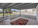 Covered back patio featuring a concrete slab, geometric carpet, and block fencing at 6553 Baywood Ave, Las Vegas, NV 89103