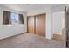 Bedroom featuring carpet flooring, a window, and a closet with wood sliding doors at 6553 Baywood Ave, Las Vegas, NV 89103