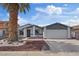 Single story home featuring a desert landscape, covered entryway, 2 car garage and mature palm tree at 6553 Baywood Ave, Las Vegas, NV 89103