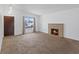 Inviting living room featuring a fireplace and a large window for natural light at 6553 Baywood Ave, Las Vegas, NV 89103