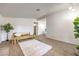 Bright living room with carpet, accent furniture, and seamless access to the dining area at 6553 Baywood Ave, Las Vegas, NV 89103