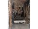 Bathroom with extensive fire damage, including burnt fixtures, exposed wood framing, and charred surfaces at 709 G St, Las Vegas, NV 89106
