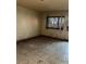 Bedroom featuring outdated window, tile flooring, and damaged walls requiring renovation at 709 G St, Las Vegas, NV 89106