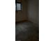 Minimalist bedroom, with bare walls, simple window, and concrete flooring at 709 G St, Las Vegas, NV 89106