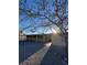 View of exterior showing the flat roof, covered patio, and arid landscape around the property at 709 G St, Las Vegas, NV 89106