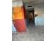 Hallway with damaged walls, painted graphics, and ceramic tile floors, showing deferred maintenance at 709 G St, Las Vegas, NV 89106