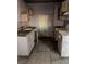 Outdated kitchen with damaged cabinetry, stained counters, and aged appliances needing complete renovation at 709 G St, Las Vegas, NV 89106