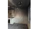 Fire-damaged kitchen area with charred walls, damaged cabinetry and flooring, and exposed window frame at 709 G St, Las Vegas, NV 89106