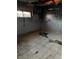 Damaged room shows cracked ceramic tile floors, graffiti on walls, and missing drywall at 709 G St, Las Vegas, NV 89106