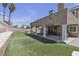 Well-maintained backyard featuring a covered patio and artificial turf for easy upkeep at 7197 Sixshooter Dr, Las Vegas, NV 89119