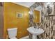 Well-decorated bathroom with ornate mirror and fixtures, and striking tile and wallpaper at 7197 Sixshooter Dr, Las Vegas, NV 89119