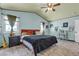 Comfortable bedroom with large windows, ample natural light, and a ceiling fan at 7197 Sixshooter Dr, Las Vegas, NV 89119