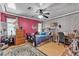 Cozy bedroom with vibrant pink walls, zebra wallpaper, hardwood floors, and ceiling fan at 7197 Sixshooter Dr, Las Vegas, NV 89119