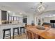 Open dining area with a modern light fixture and kitchen access featuring granite countertops and stainless steel appliances at 7197 Sixshooter Dr, Las Vegas, NV 89119