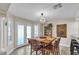 Bright dining area with stylish table and chairs, modern lighting, and French doors at 7197 Sixshooter Dr, Las Vegas, NV 89119