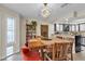 Bright dining area with stylish table and chairs, modern lighting, and French doors at 7197 Sixshooter Dr, Las Vegas, NV 89119