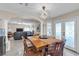 Bright dining area with stylish table and chairs, modern lighting, and French doors at 7197 Sixshooter Dr, Las Vegas, NV 89119