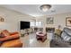 Cozy living room with tile flooring, a chandelier, leather seating, and a fireplace at 7197 Sixshooter Dr, Las Vegas, NV 89119