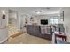 Open-concept living room with tile flooring, a chandelier, leather seating, stairs, and neutral paint at 7197 Sixshooter Dr, Las Vegas, NV 89119