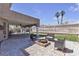 Inviting covered patio area with a fire pit and seating, perfect for outdoor gatherings at 7197 Sixshooter Dr, Las Vegas, NV 89119