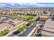 Expansive community featuring a gated entrance, green spaces, and mountain views at 7517 Crested Moon St, North Las Vegas, NV 89084