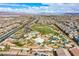 Expansive aerial view of a Primary-planned community showcasing lush green spaces and a neighborhood park at 7517 Crested Moon St, North Las Vegas, NV 89084