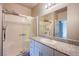 Bathroom featuring tiled shower and vanity with stone countertop at 7517 Crested Moon St, North Las Vegas, NV 89084