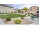 Well-maintained common area featuring lush landscaping, seating, and walking paths at 7517 Crested Moon St, North Las Vegas, NV 89084