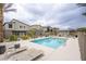 Sparkling community pool with lounge chairs, surrounded by lush landscaping and modern homes at 7517 Crested Moon St, North Las Vegas, NV 89084