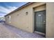 Side exterior view showing a brick pathway, the front door and desert landscaping at 7517 Crested Moon St, North Las Vegas, NV 89084