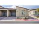 Modern exterior elevation with desert landscaping, brick driveway and gray two-car garage doors at 7517 Crested Moon St, North Las Vegas, NV 89084