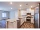 Modern kitchen features white cabinets, stainless appliances, and a spacious island at 7517 Crested Moon St, North Las Vegas, NV 89084