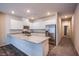 Bright kitchen features white cabinets, granite countertops, stainless steel appliances and a large island at 7517 Crested Moon St, North Las Vegas, NV 89084
