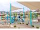 Colorful playground with slides and climbing structures, shaded by modern canopies for ' enjoyment at 7517 Crested Moon St, North Las Vegas, NV 89084