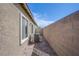 Paver side yard showing AC unit with stucco wall and blue skies at 7517 Crested Moon St, North Las Vegas, NV 89084