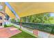 Lush backyard featuring artificial turf, a shaded patio, and privacy hedging for outdoor enjoyment at 7900 Dutch Canyon Ct, Las Vegas, NV 89131