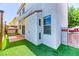Charming backyard featuring artificial grass, patio area, and privacy fencing for relaxation at 7900 Dutch Canyon Ct, Las Vegas, NV 89131