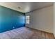 Bright bedroom with a textured accent wall, plush carpet, and a window offering natural light at 7900 Dutch Canyon Ct, Las Vegas, NV 89131