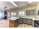 Eat-in kitchen features stainless appliances, gray cabinets, tile countertops, and access to the backyard at 7900 Dutch Canyon Ct, Las Vegas, NV 89131