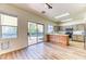 Open kitchen boasts backyard access, stainless appliances, an island, and hardwood flooring at 7900 Dutch Canyon Ct, Las Vegas, NV 89131