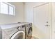 Efficient laundry room with modern washer and dryer, offering convenience and functionality at 7900 Dutch Canyon Ct, Las Vegas, NV 89131