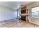 Bright living room with a modern fireplace, wood mantle, and wood-look flooring at 7900 Dutch Canyon Ct, Las Vegas, NV 89131