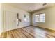 Bright living room with a front door, plank flooring, and plenty of light from the front windows at 7900 Dutch Canyon Ct, Las Vegas, NV 89131